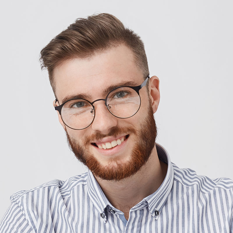 busy-smiling-bearded-male-enterpreneur-holds-pen-1-W2Y7PDS